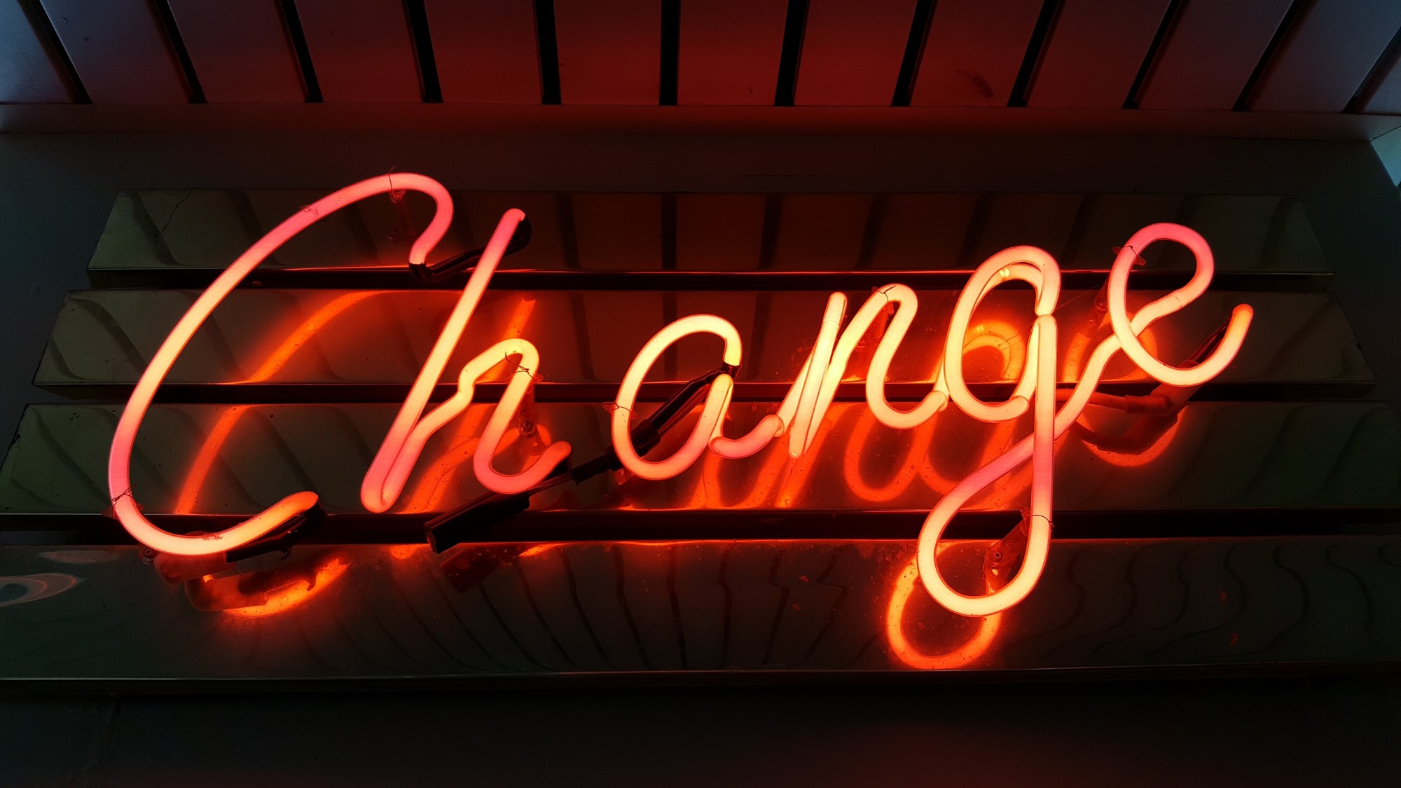 photograph of a neon sign that reads "Change"